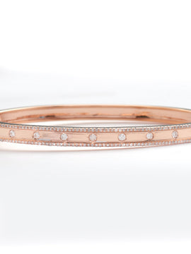 14KR 0.70CTW DIAMOND BANGLE - 9 STONE CENTER ROW